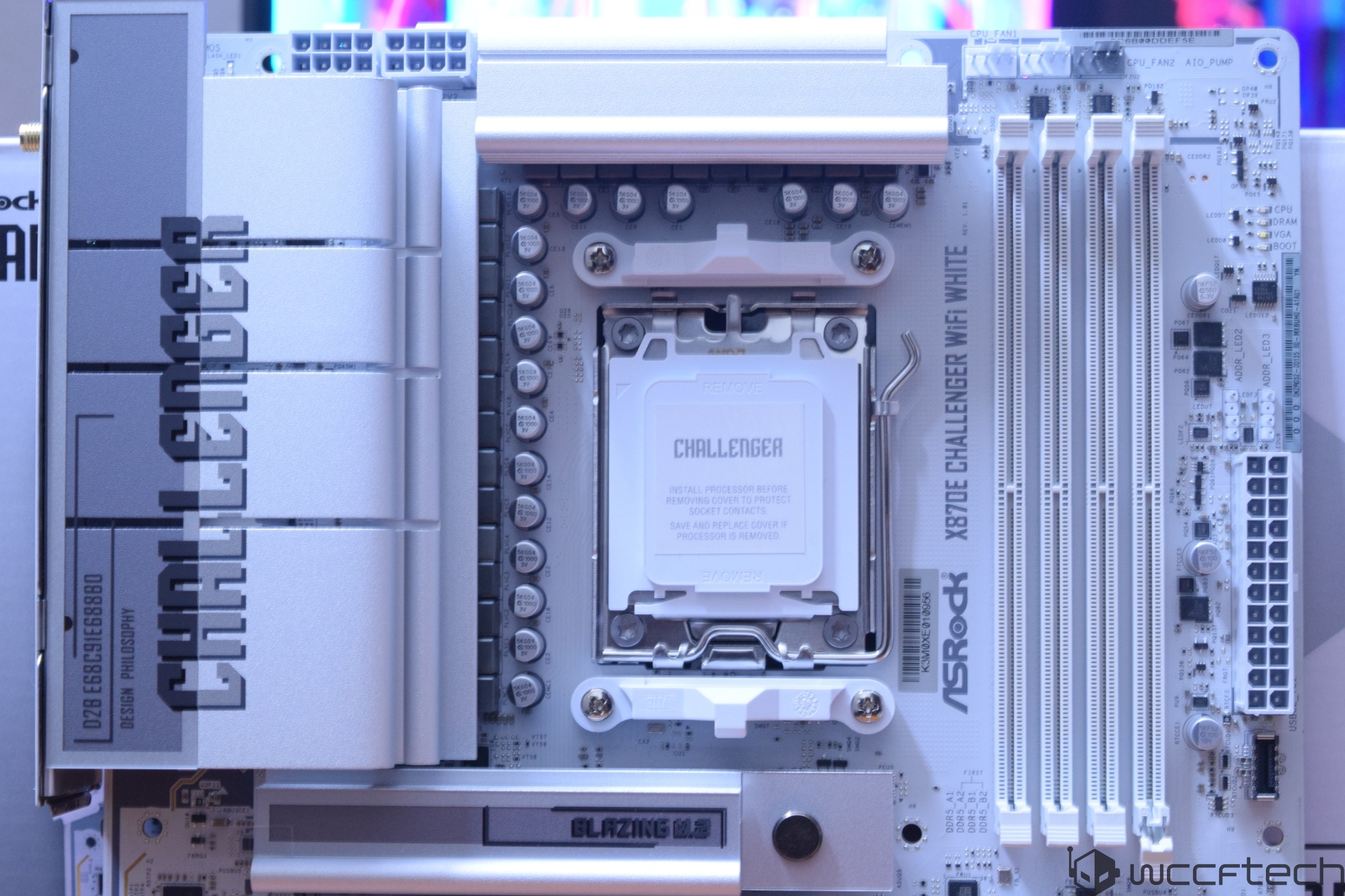 ASRock X670E Challenger WiFi motherboard with visible 'Challenger' branding and RAM slots alongside 'Blazing' text label.