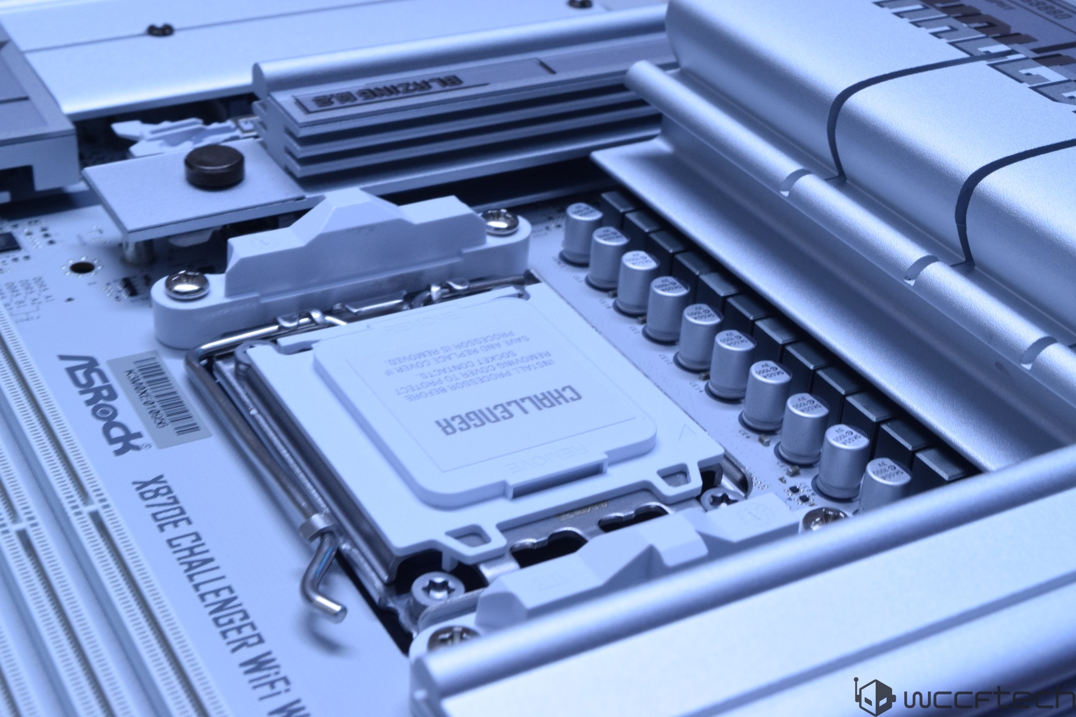 ASRock X670E Challenger WiFi motherboard with visible CPU socket and large heat sinks.