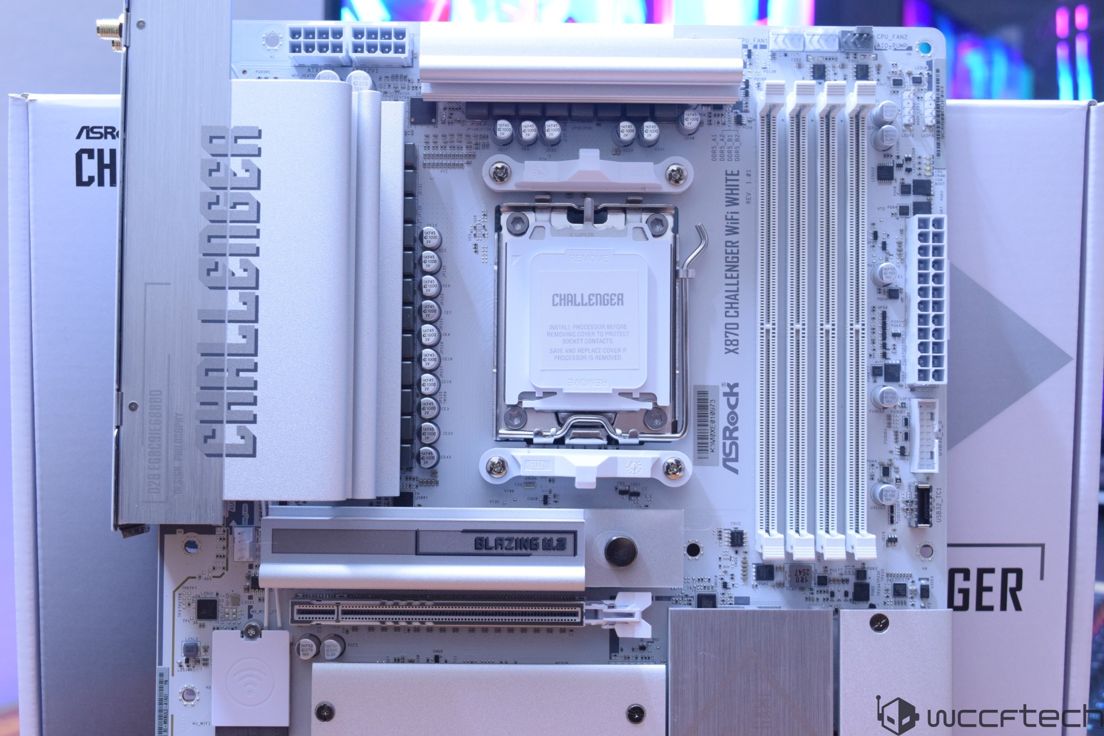 ASRock X670E Challenger WiFi White motherboard with 'Challenger' and 'Blazing M.2' branding is displayed prominently.