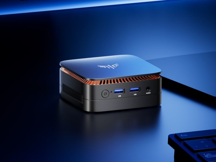 A mini PC with a sleek design features two USB ports, an audio jack, and a power button on its front panel.