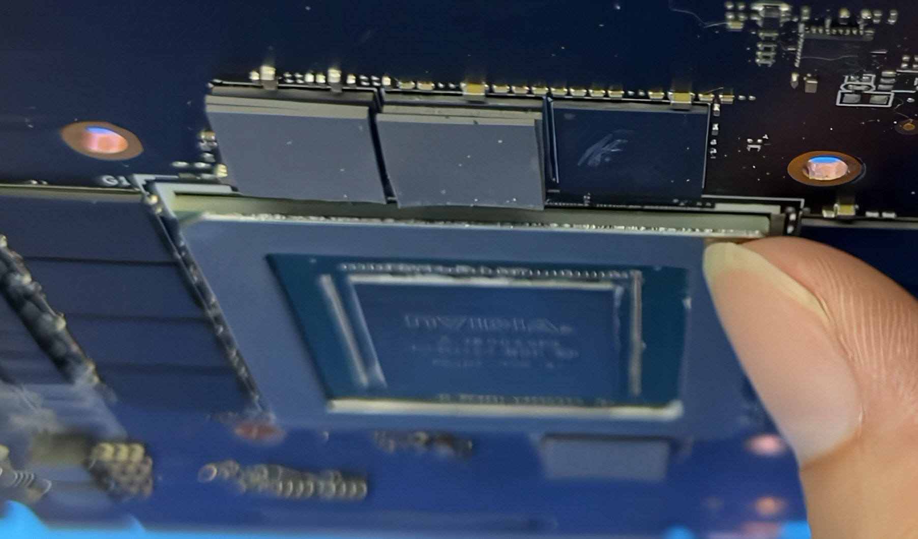 A close-up image shows a person holding an NVIDIA chip labeled 'A1809'.