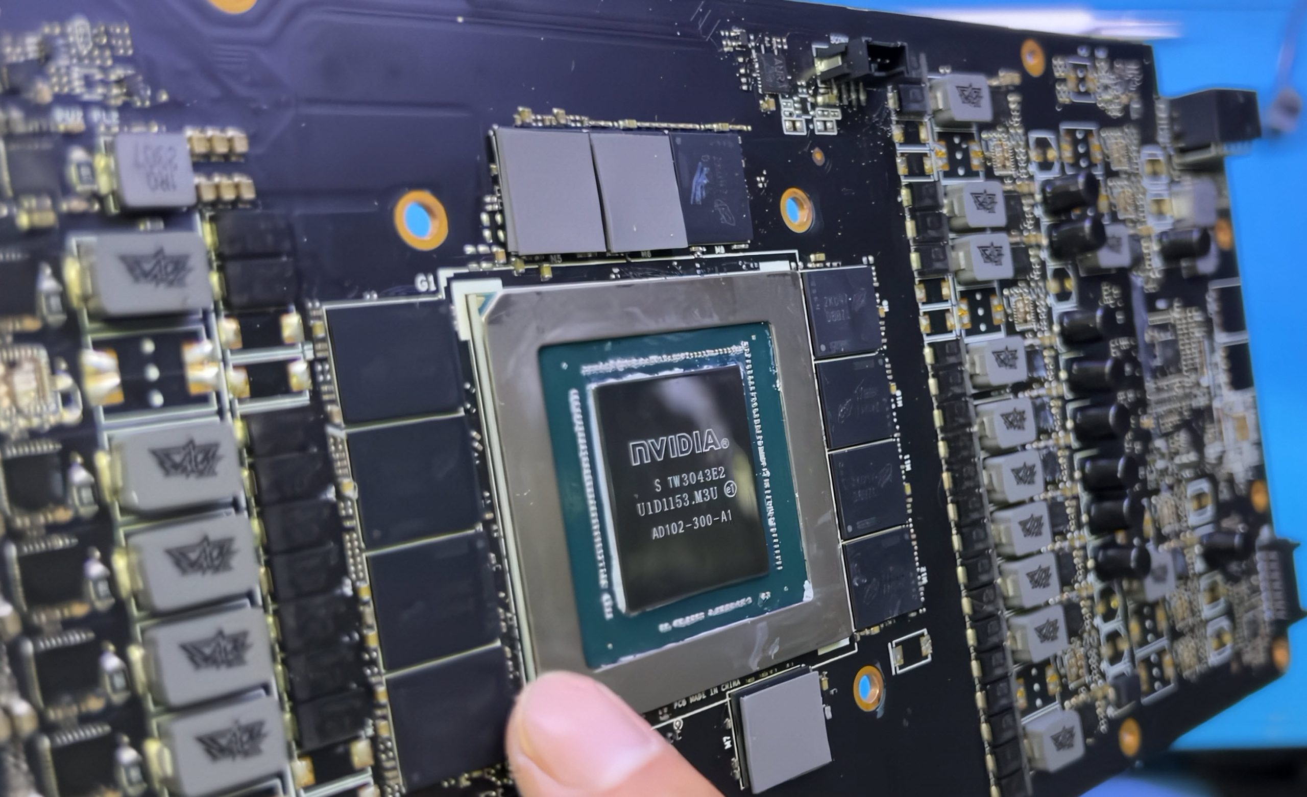 A close-up of an NVIDIA GPU chip labeled 'AD102-300-A1' mounted on a graphics card PCB.