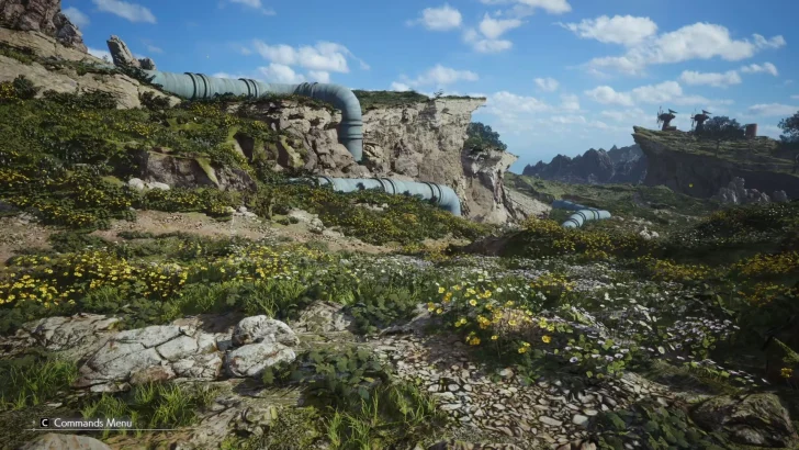 A scenic landscape in a video game shows rocky cliffs, green foliage, and yellow flowers with a large pipe running across the terrain, while the interface displays 'C: Commands Menu'.