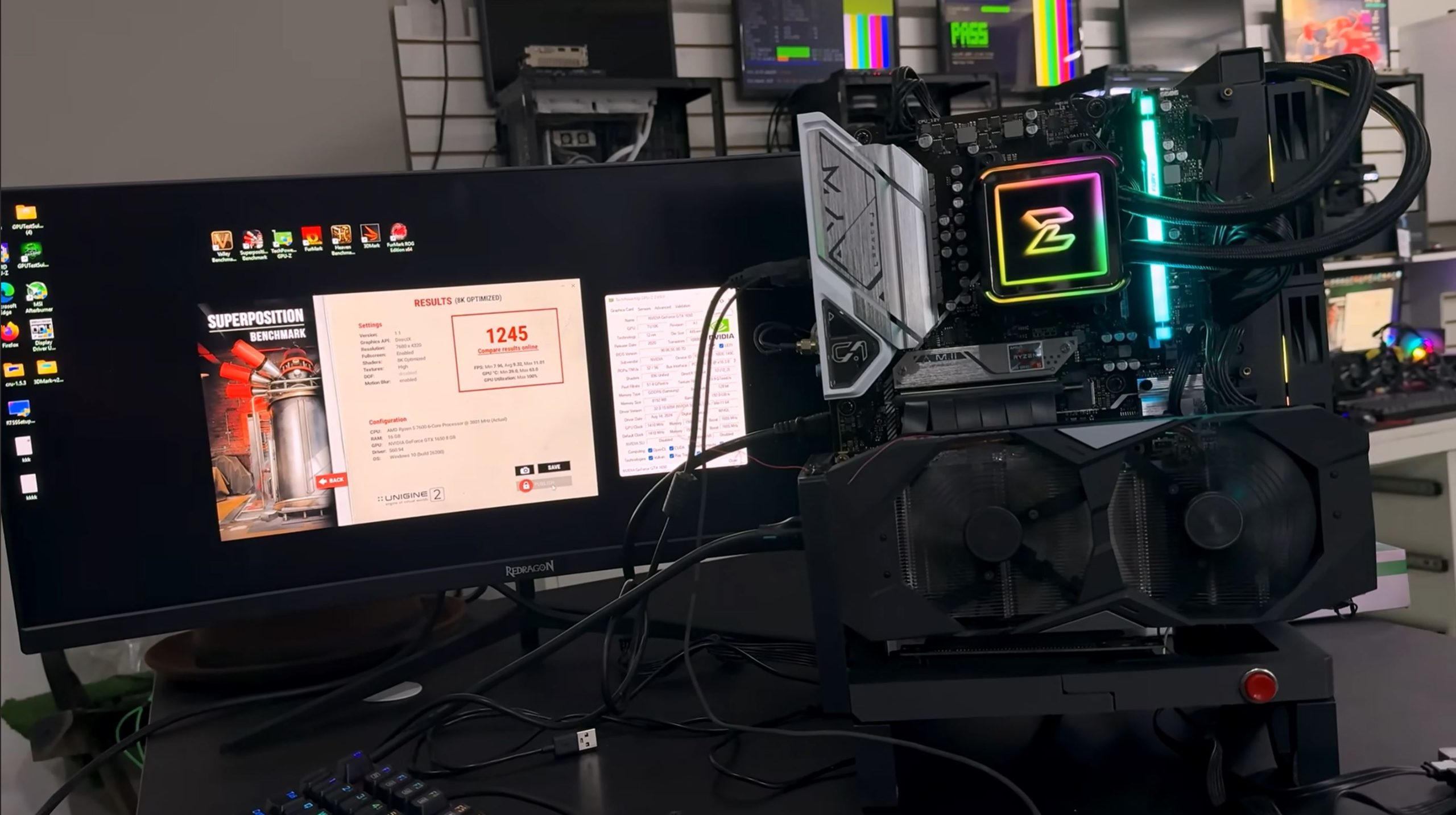 A computer monitor displays a 'Superposition Benchmark' result with a score of '1245,' alongside a desktop setup featuring an unbranded motherboard with RGB lighting.