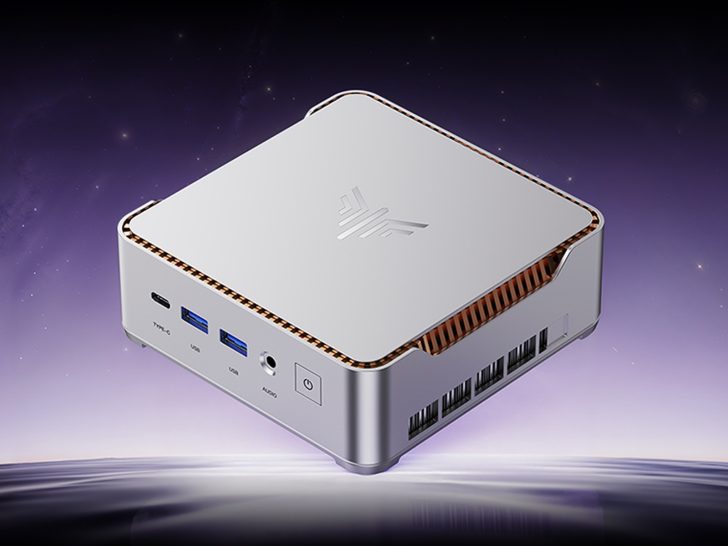 KAMRUI compact mini PC with a silver case featuring multiple ports including two USB, one Type-C, audio jack, and a power button on the front.