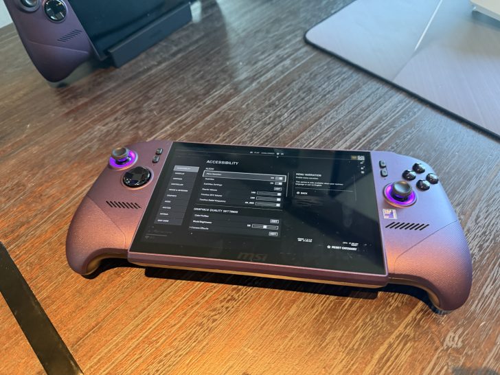An MSI handheld gaming console displaying an 'Accessibility' settings menu on a wooden table.