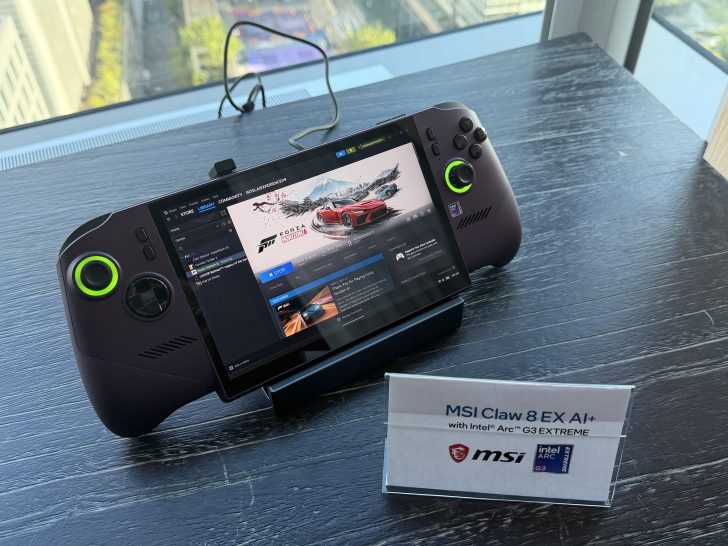 The MSI Claw 8 EX AI+ handheld console, featuring Intel Arc G3 EXTREME, displays the game 'Forza Horizon 5' on its screen, placed on a stand with a city view background.