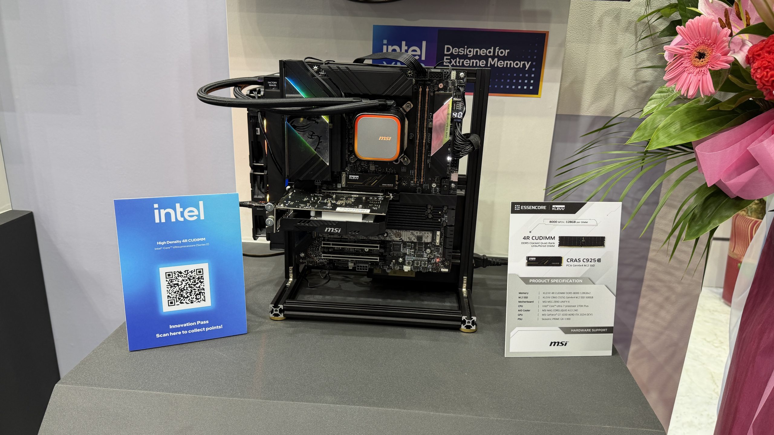 An MSI test bench displaying a motherboard with an MSI cooler, an Intel sign labeled 'High Density 4R CUDIMM,' and a KLEVV ESSENCORE CRAS C925 SSD product specification card.