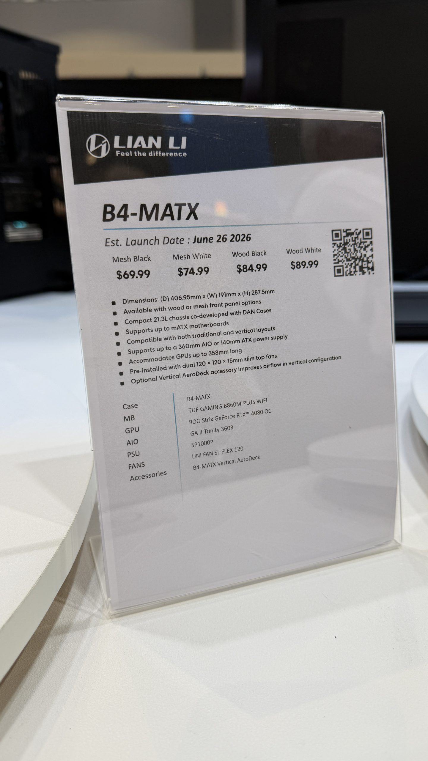 A sign displaying details for the Lian Li B4-MATX case shows an estimated launch date of June 26, 2026, with different pricing for versions in Mesh Black, Mesh White, Wood Black, and Wood White.
