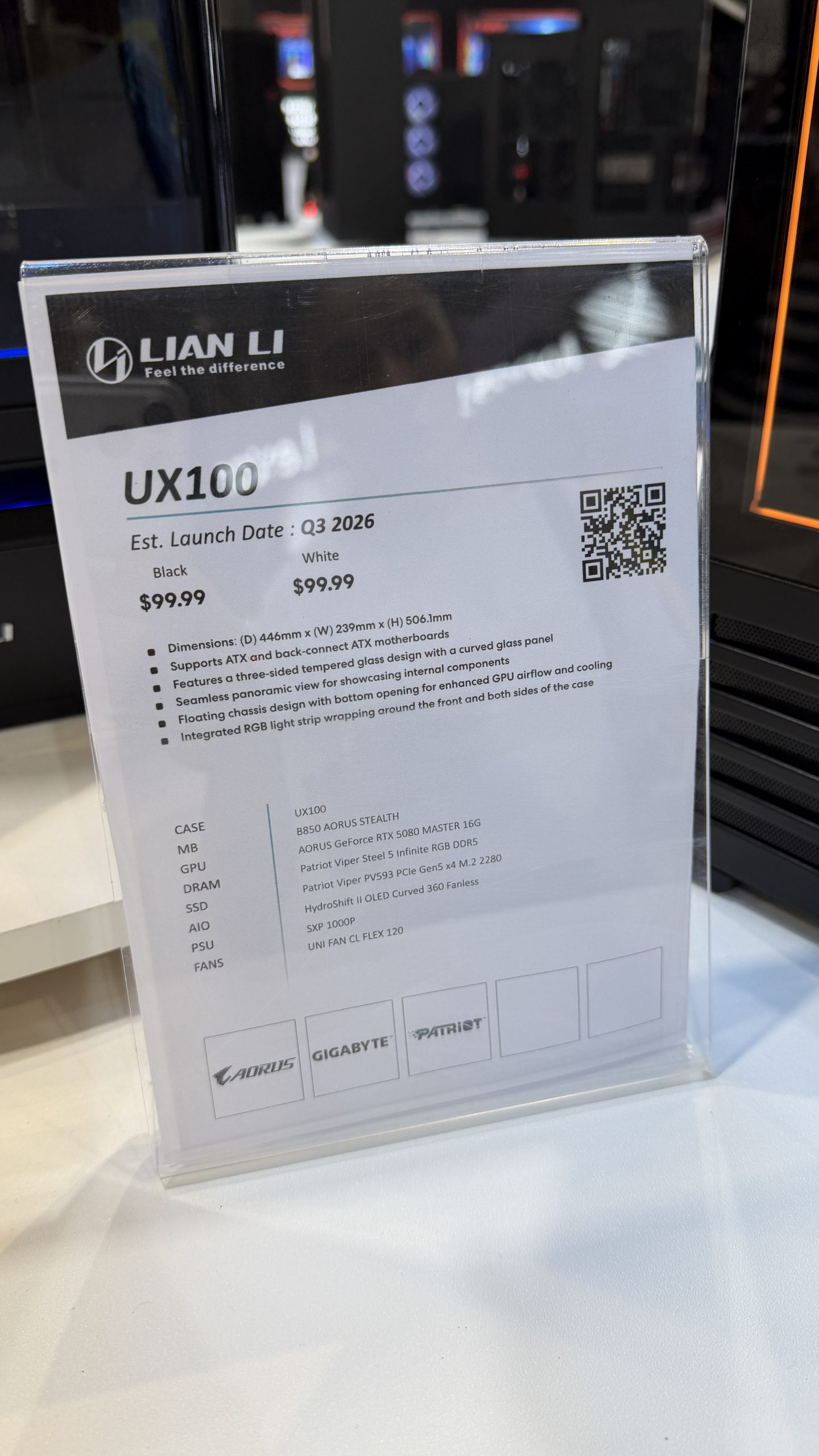 A Lian Li advertisement for the UX100 case, priced at $99.99, with an estimated launch date of Q3 2026, featuring specifications for an AORUS GeForce RTX 5080 MASTER 16G and other components.