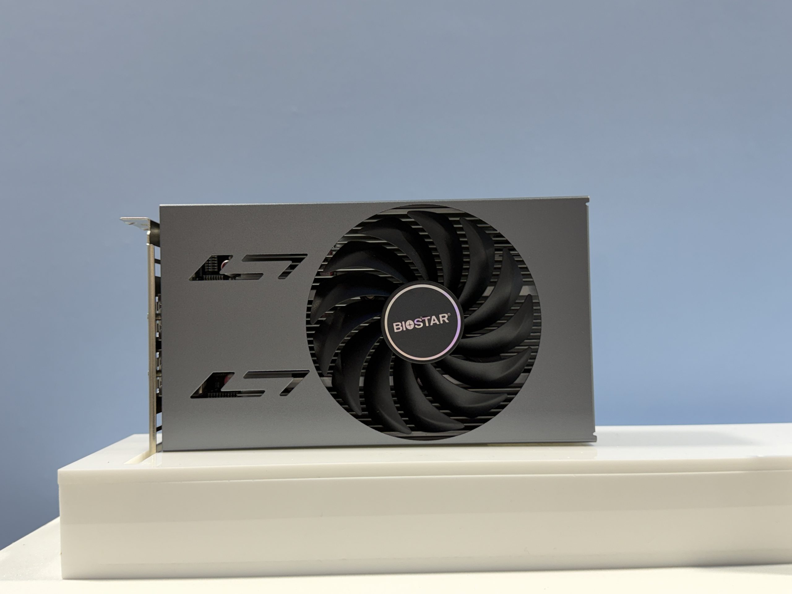 A Biostar graphics card with a large cooling fan is displayed against a plain background.