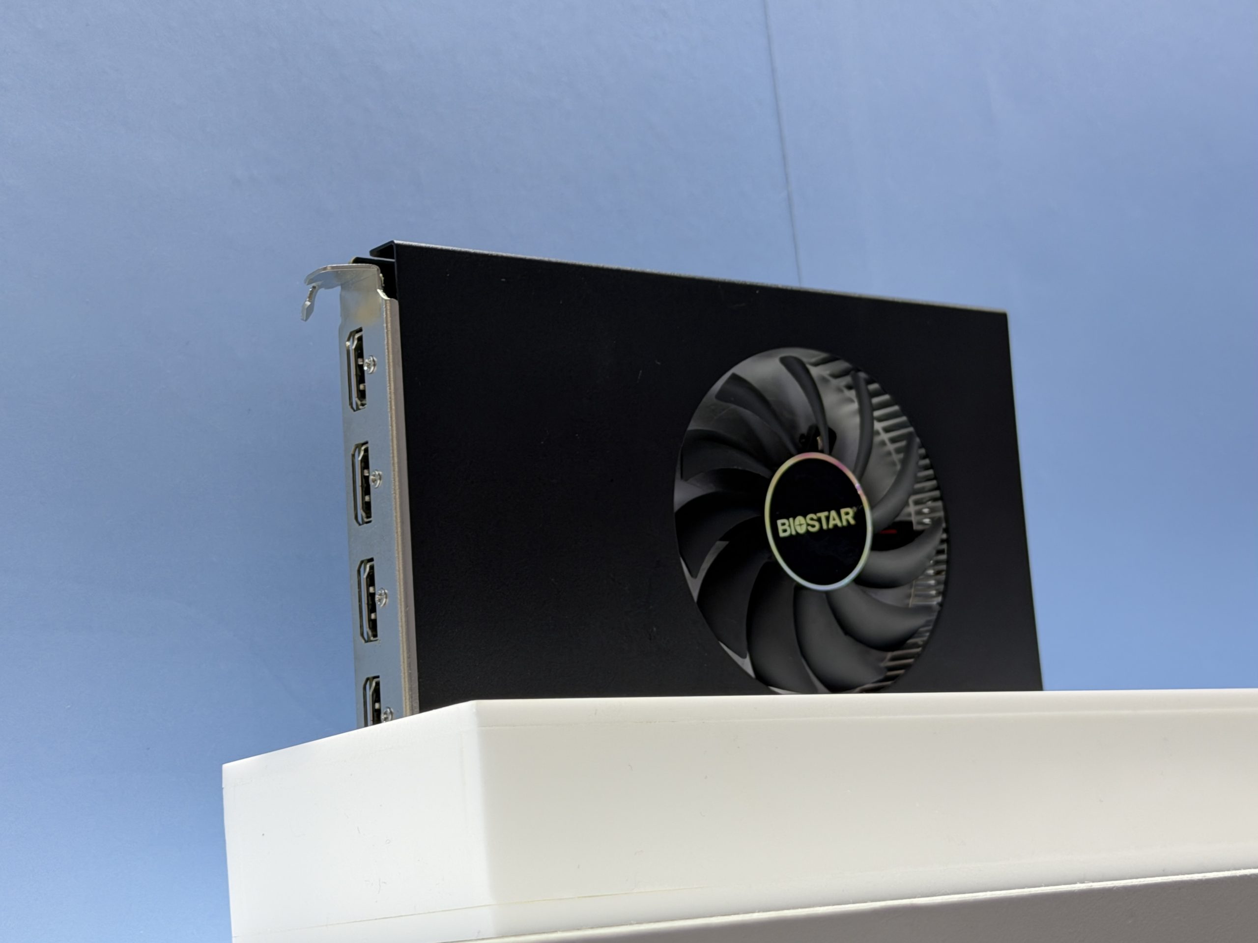 The Biostar graphics card features four display ports and a cooling fan with the Biostar logo.