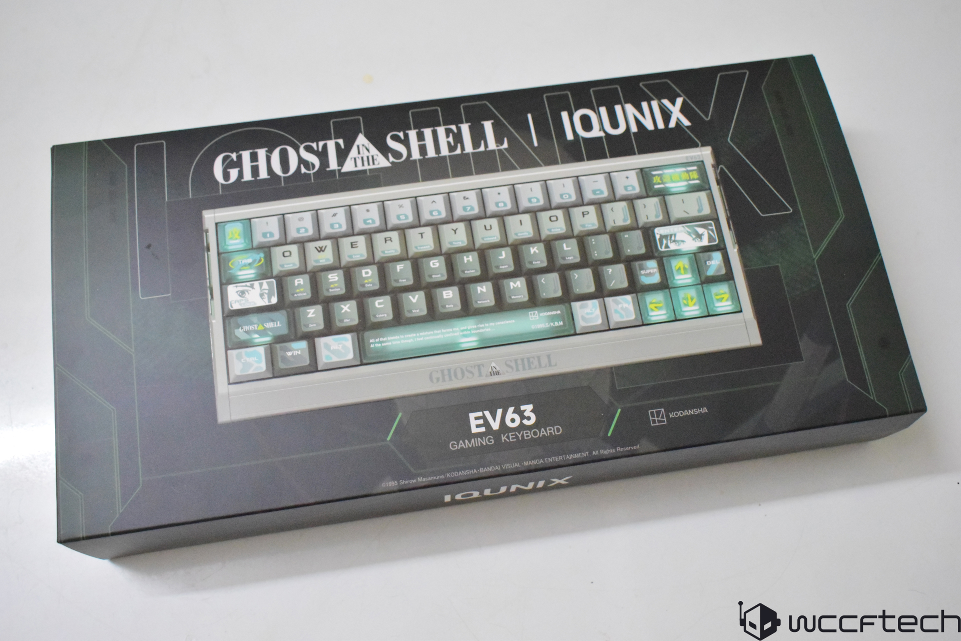 Iqunix Ghost In The Shell EV63 gaming keyboard packaging displays the keyboard with custom keycaps featuring themed graphics and branding.