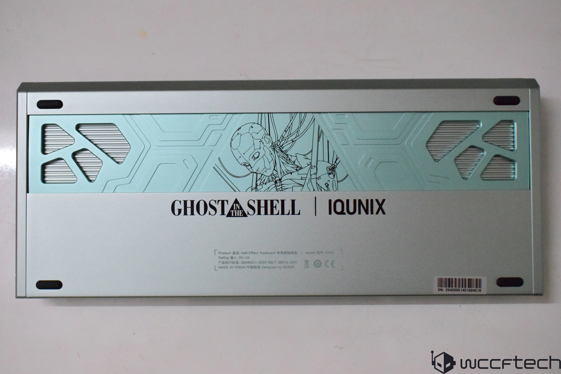 The back of an IQUNIX keyboard features a Ghost in the Shell themed design with an illustrated motif and branding text.