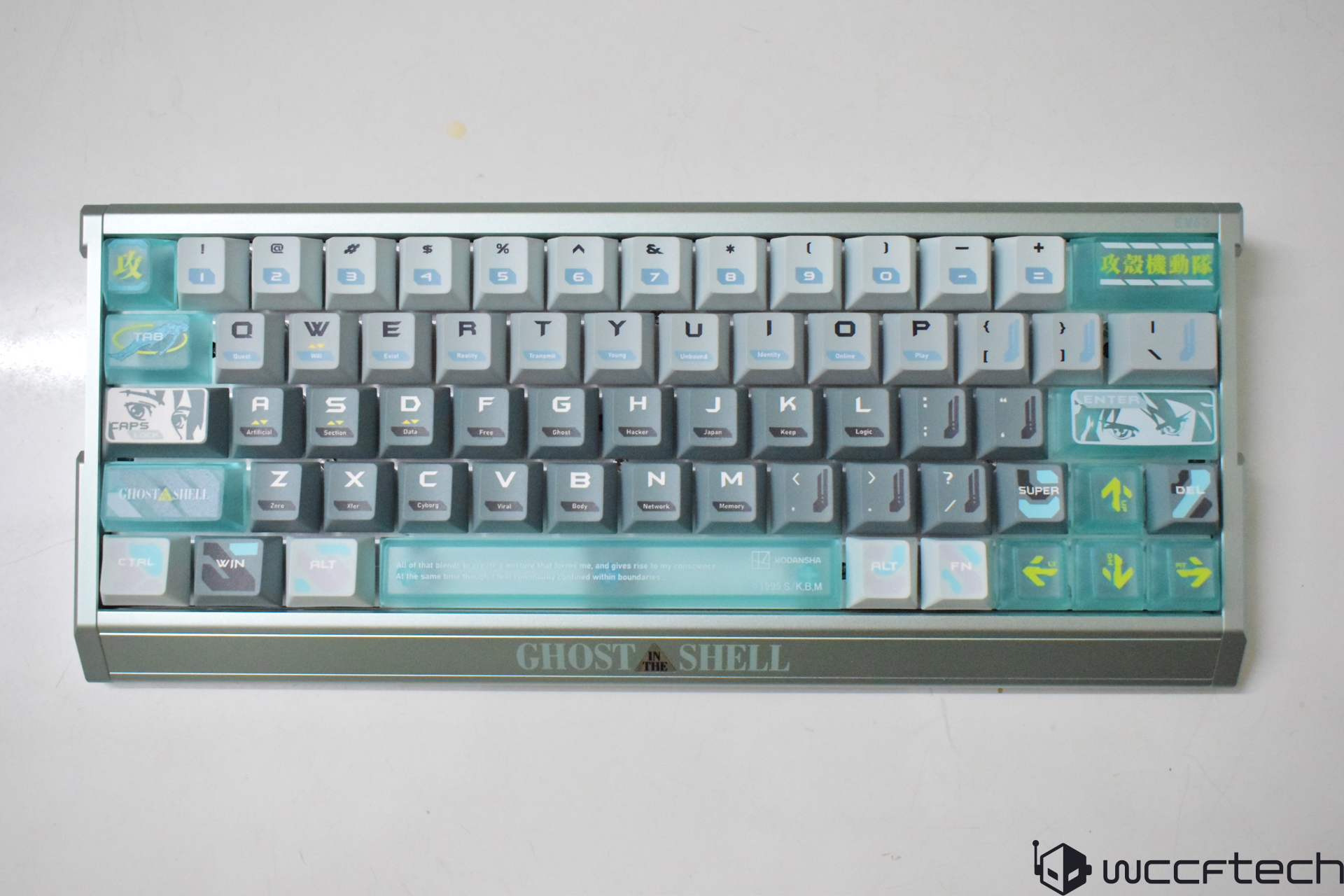 A Ghost in the Shell-themed mechanical keyboard featuring custom keycaps with graphic elements and text, including 'QUERTY,' 'ENTER,' and a distinctive anime-inspired design.