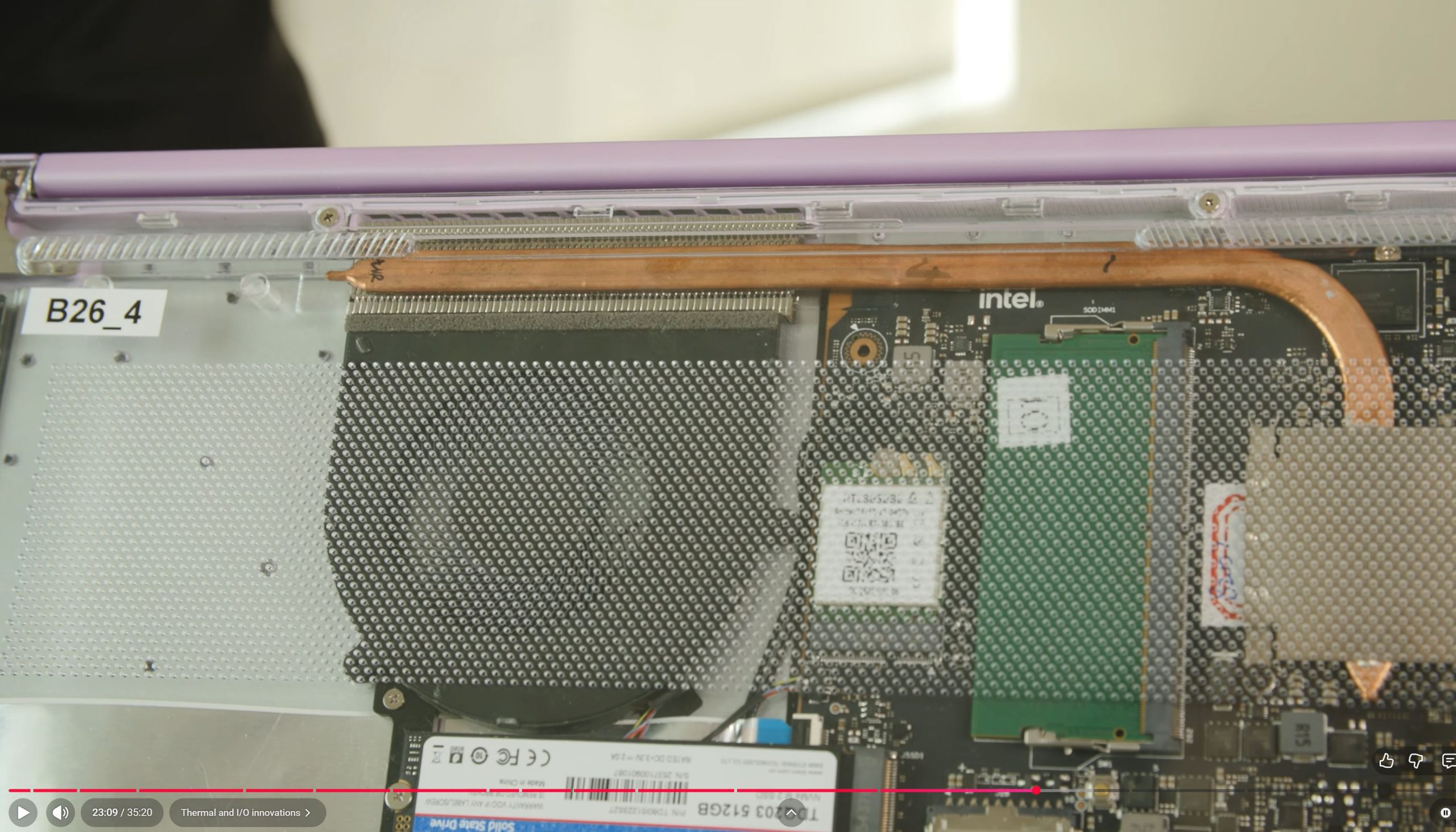 A close-up of a laptop's internal components featuring an Intel processor and visible copper heat pipe along with a B26_4 label.