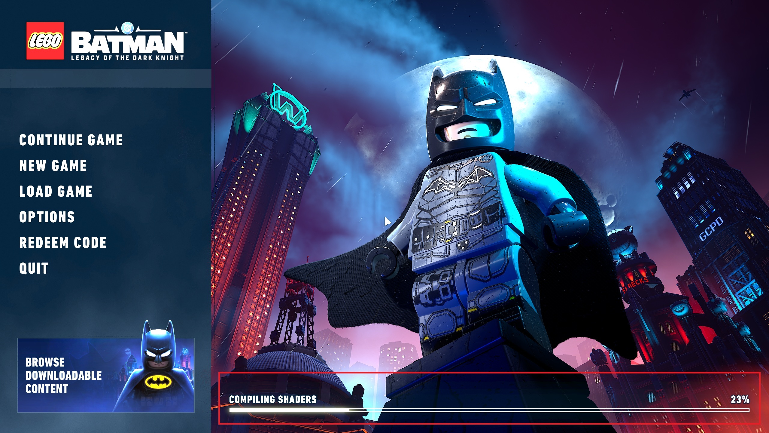 The game menu of 'LEGO Batman: Legacy of the Dark Knight' with options like 'Continue Game' and 'New Game' visible alongside a background image of LEGO Batman and Gotham City, displaying the text 'Compiling Shaders' at 23%.