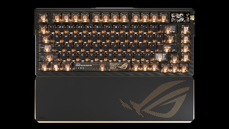The ASUS ROG branded mechanical keyboard features golden key backlighting and a palm rest with the 'ROG' logo design.