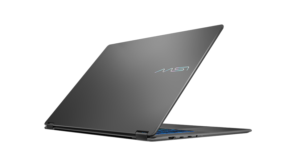 A gray MSI laptop with its lid partially open, showcasing the MSI logo on the cover and featuring various ports on the side.