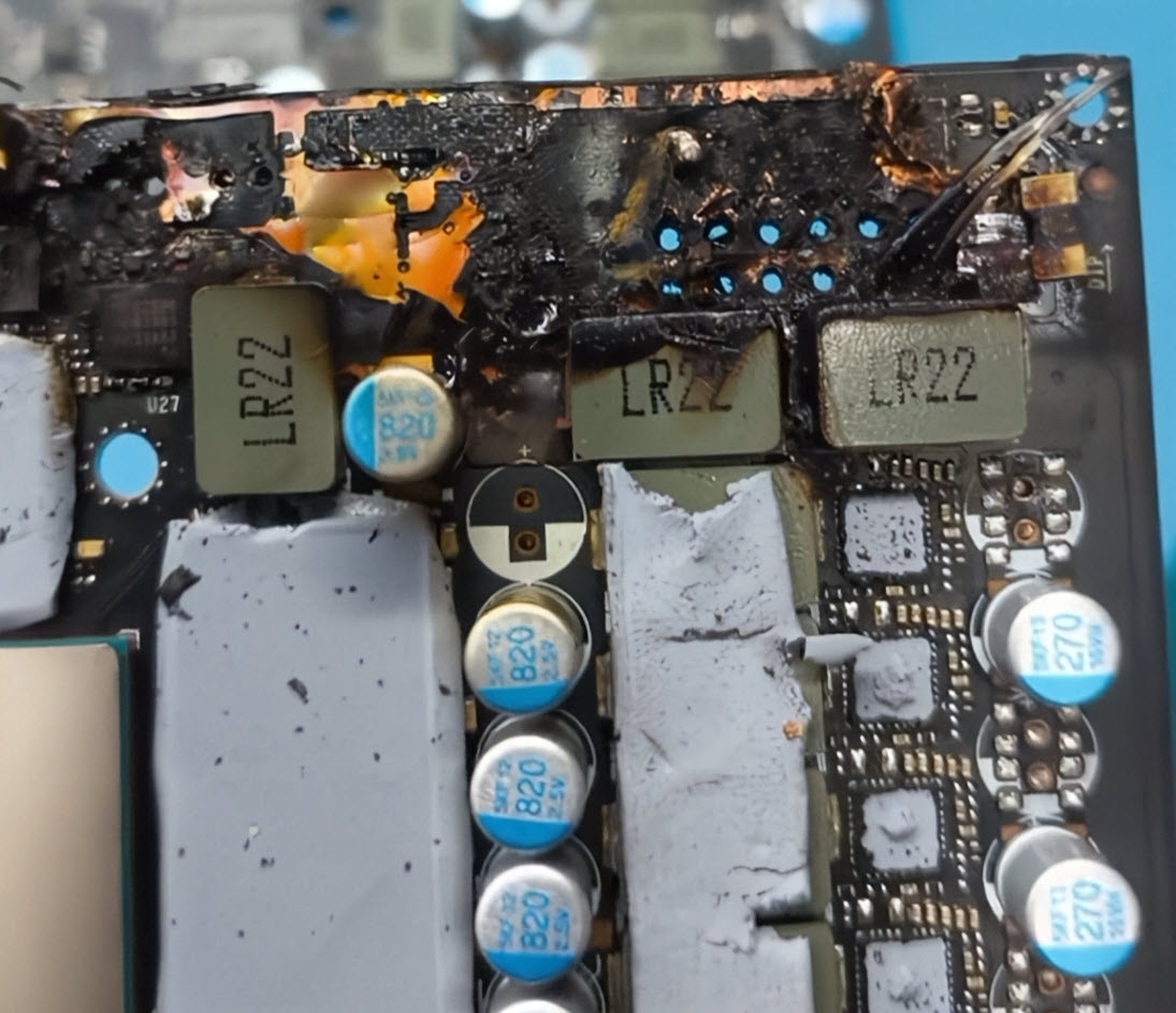 A burnt circuit board with visible damage and components labeled 'LR22' and capacitors marked '820'.