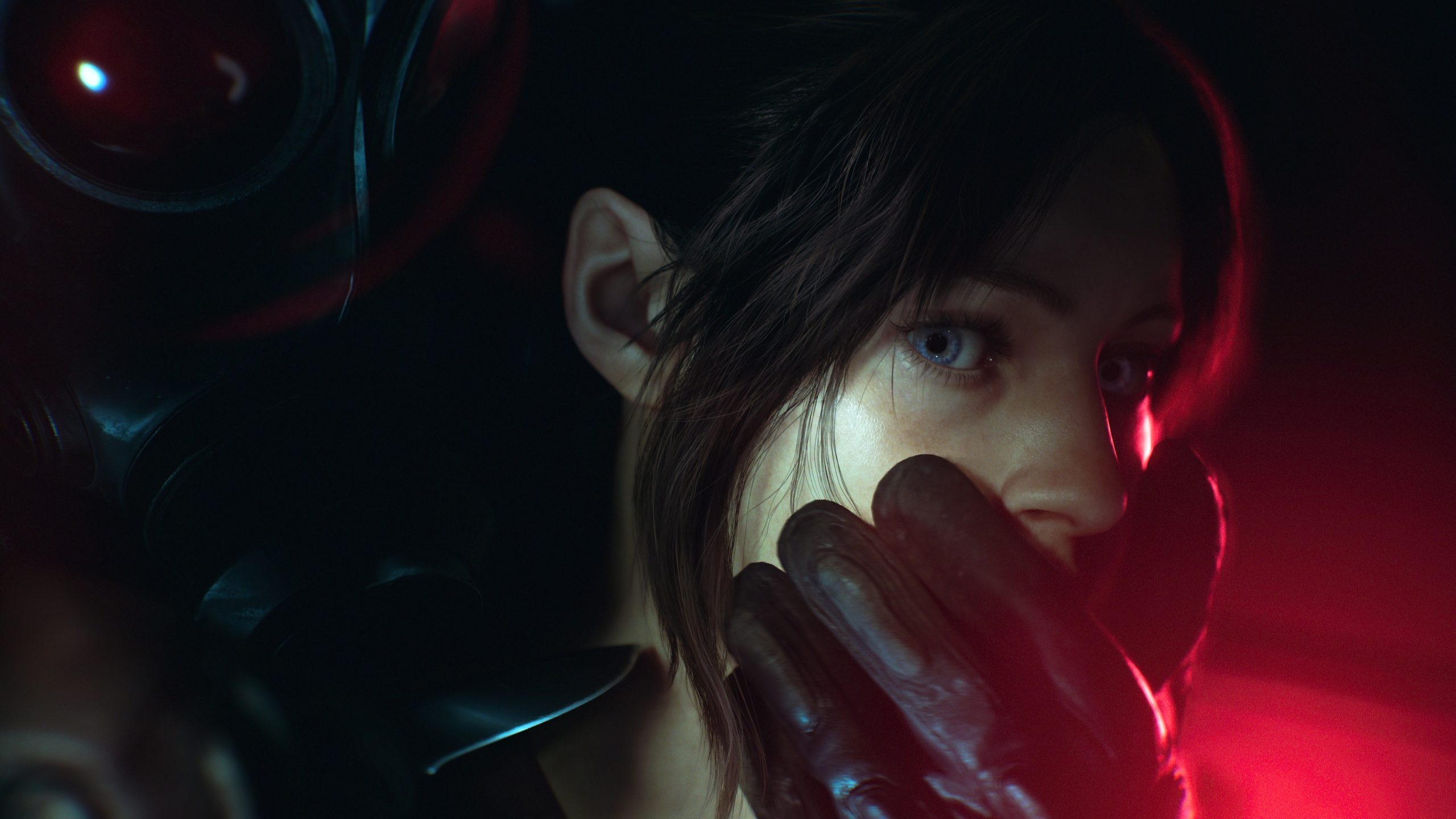 A character from the Resident Evil series is up close with a gloved hand covering their mouth in a dimly lit environment.