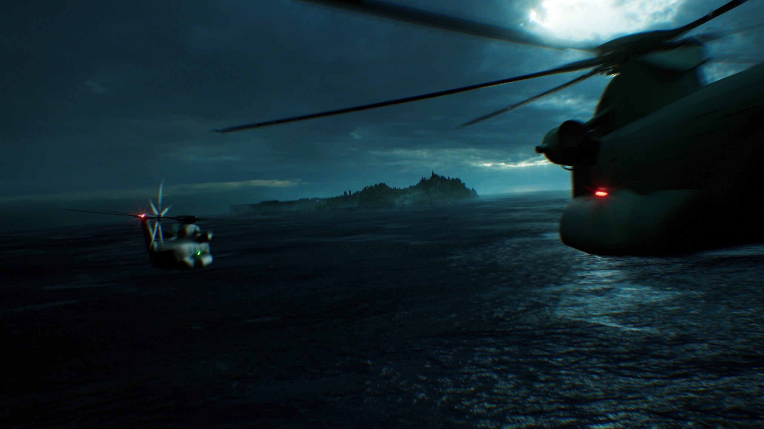 Two military helicopters flying over the ocean towards a distant island under a cloudy sky.