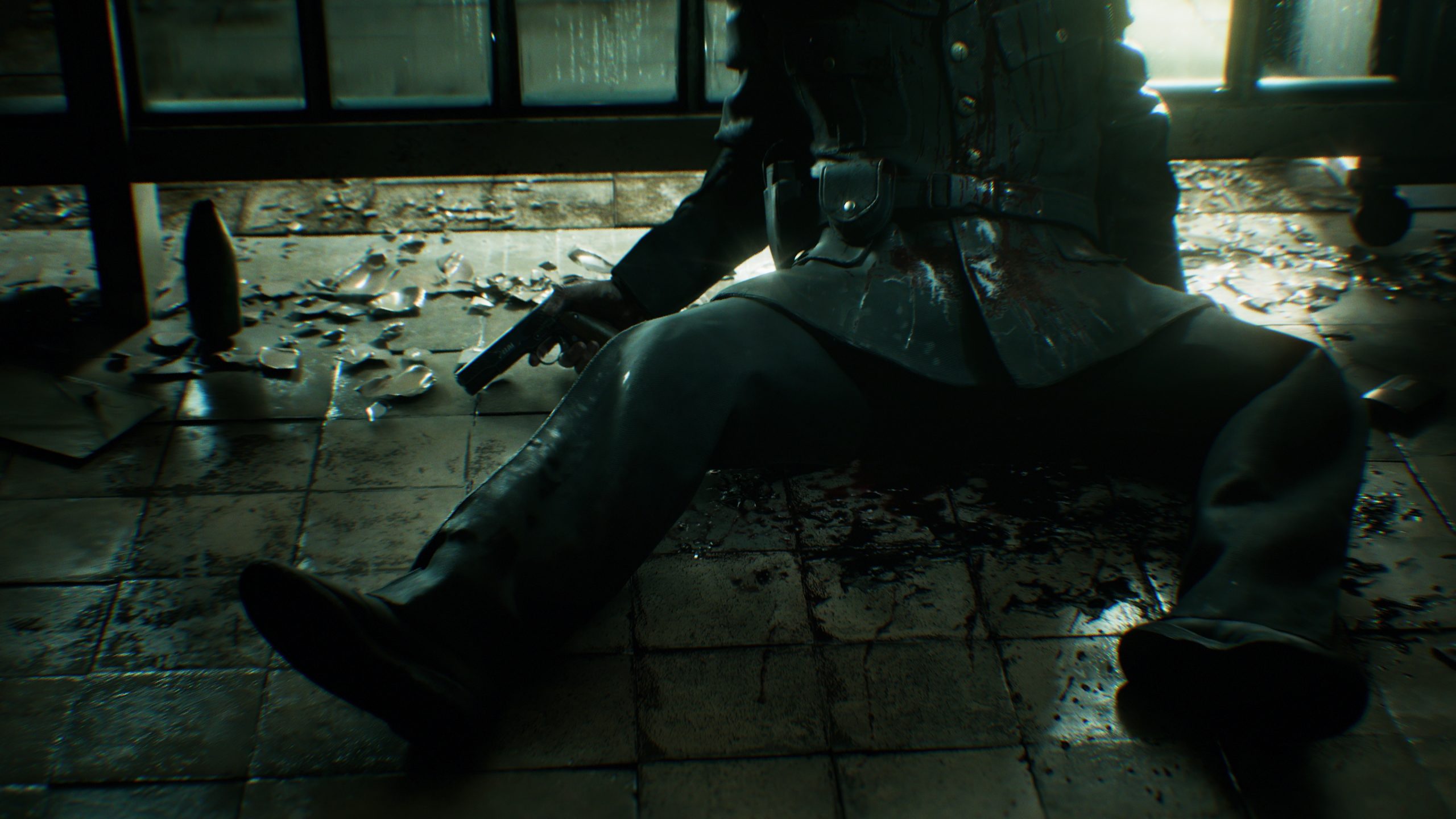 A soldier in a military uniform is sitting on a blood-stained, broken glass-covered floor, holding a pistol in a dimly lit room.