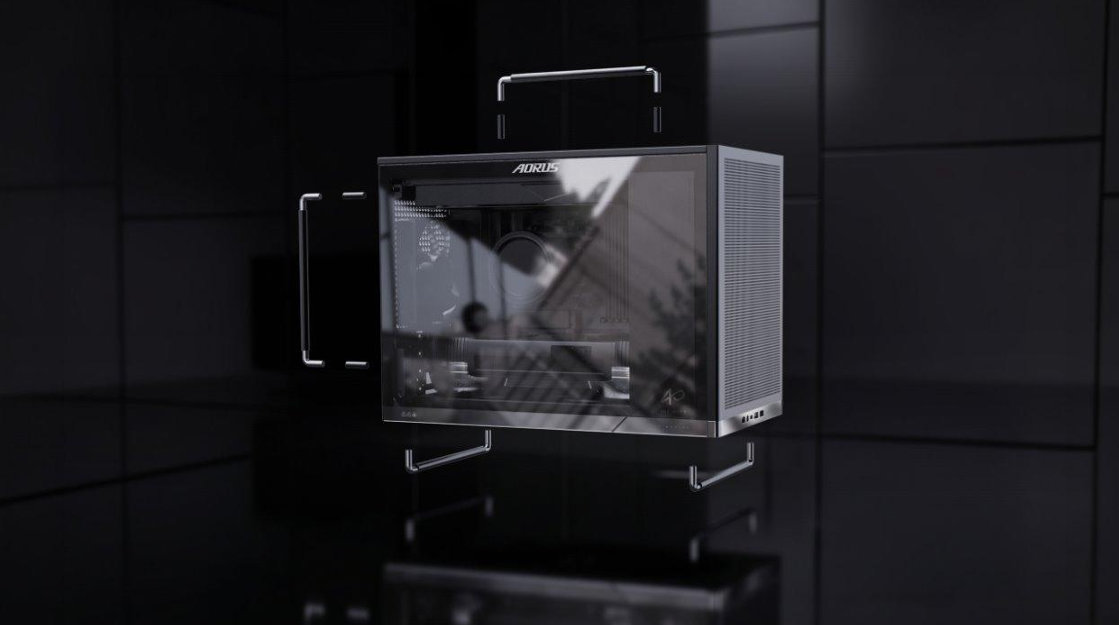 An AORUS gaming PC case with a transparent side panel is suspended in a dark room, showcasing its sleek design and front I/O ports.
