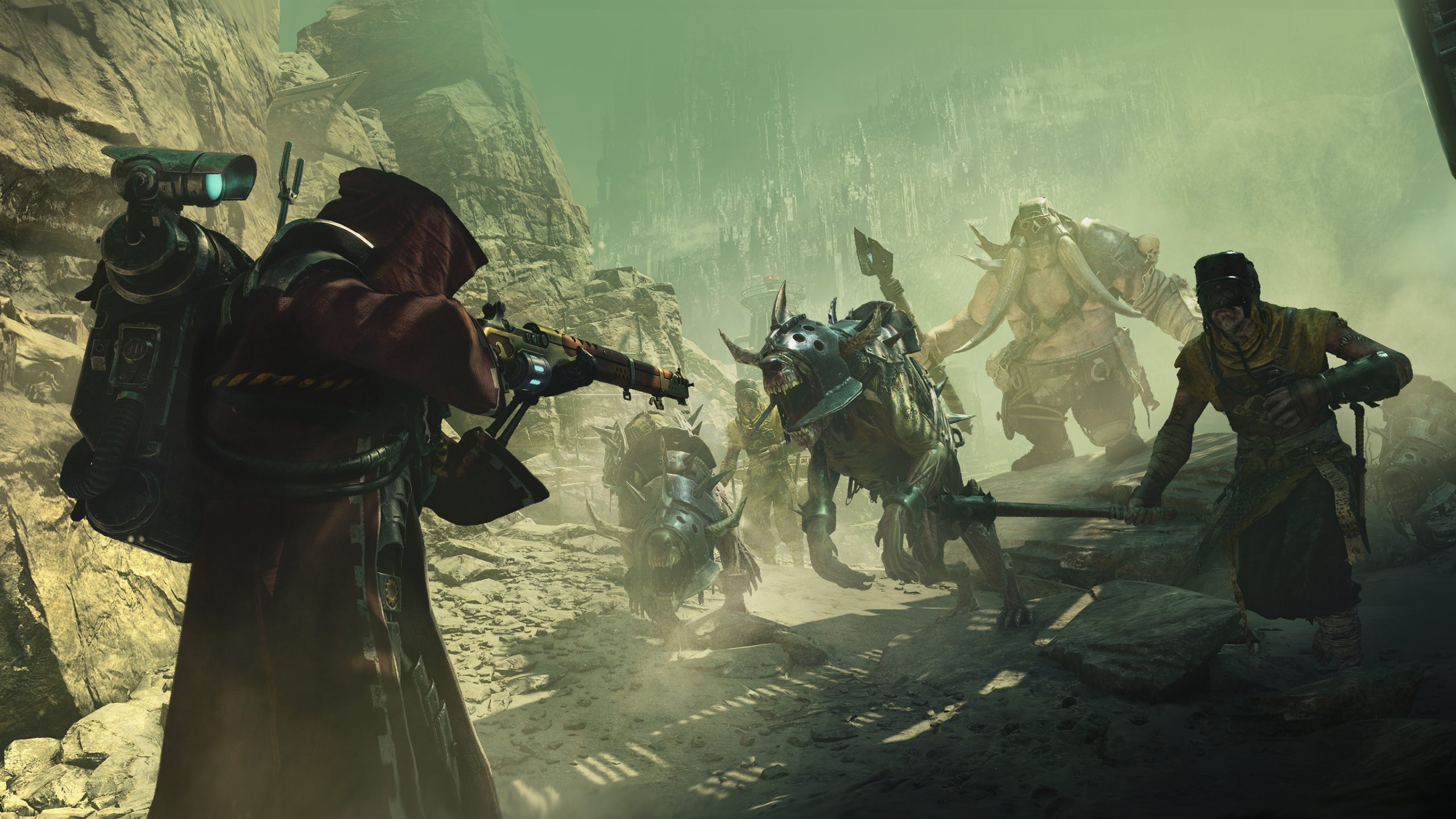 A character in 'Warhammer 40,000: Darktide' aims a weapon at approaching armored beasts and figures in a rocky, dystopian landscape.