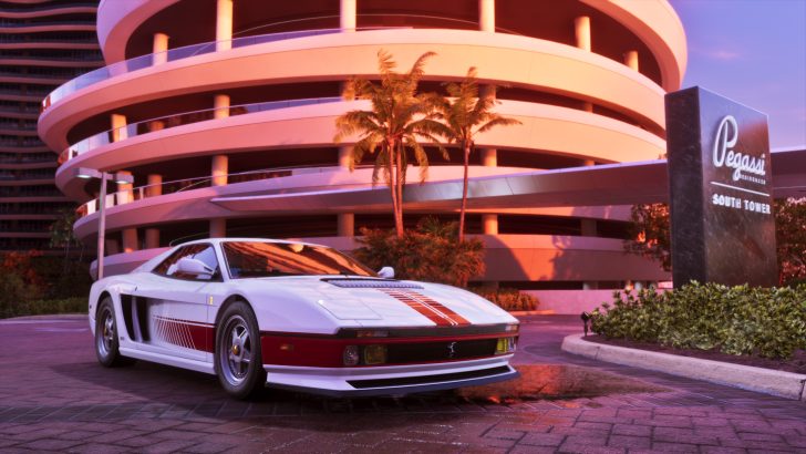 A white sports car with red accents is parked in front of the 'Pegassi Residences South Tower' building in a sunlit urban setting.