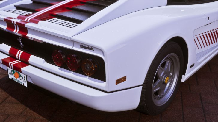 A white sports car rear, labeled 'Cheetah,' with custom red stripes and a license plate reading 'GA68BAA' from 'GODOTIME STATE'.