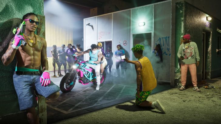 A vibrant scene from the video game GTA Online, featuring characters in colorful attire around a neon-accented motorcycle, with one character holding a phone to capture the moment.