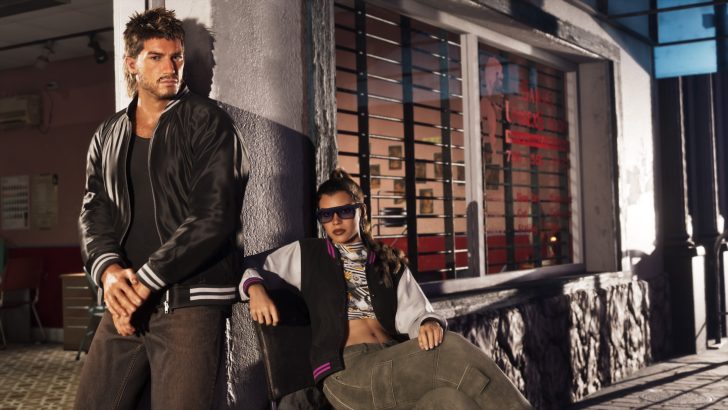 Two characters from 'Grand Theft Auto VI' leaning against a building with barred windows.