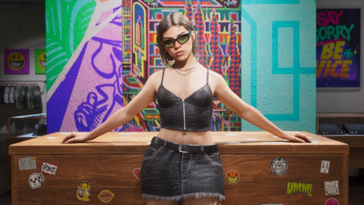 A character in 'Cyberpunk 2077' wearing sunglasses and a black leather top stands confidently in front of a colorful graffiti mural.