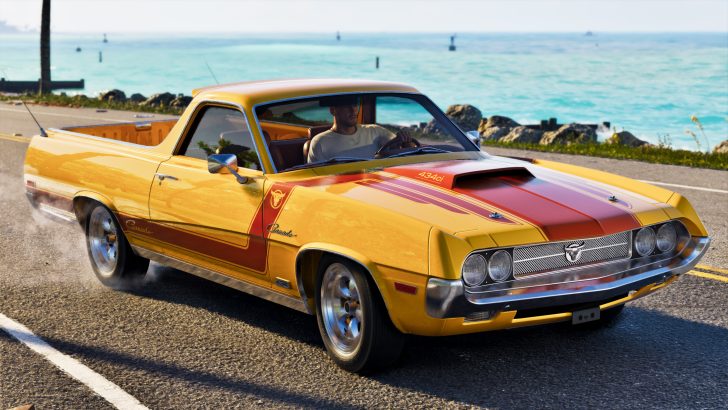 A yellow 'Canada 434ci' muscle car with red stripes is driven by a man on a coastal road.