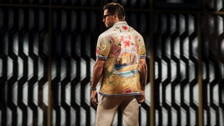 A character in 'Grand Theft Auto VI' wearing a brightly patterned shirt with tropical designs and flamingos stands in front of a geometric patterned wall.
