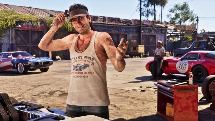 A character from the game 'Grand Theft Auto V' stands in a garage setting holding a wrench, with two cars visible in the background, one red with the number 36 and another with a star-spangled design.
