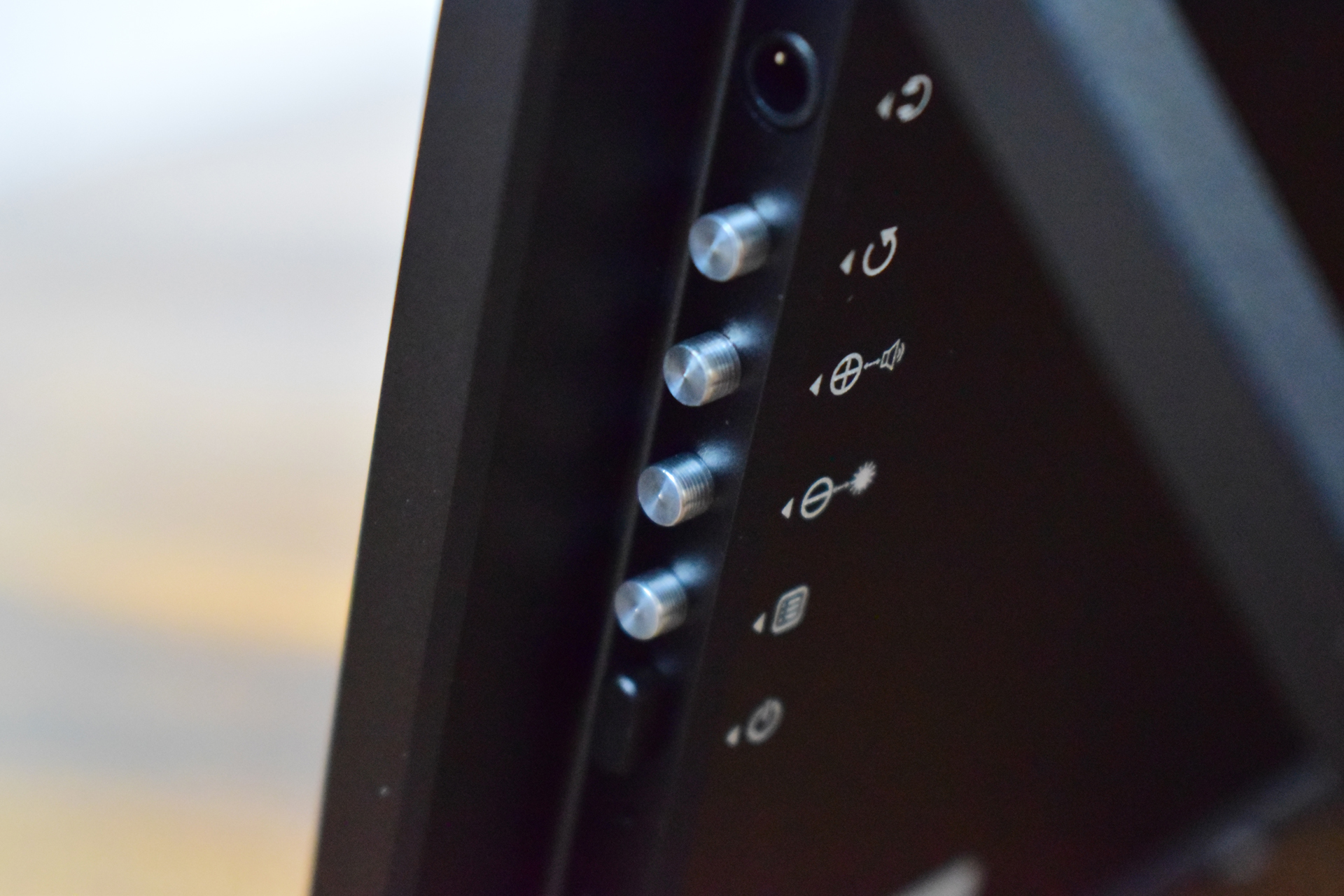 Close-up of control buttons and icons on an unbranded electronic device.