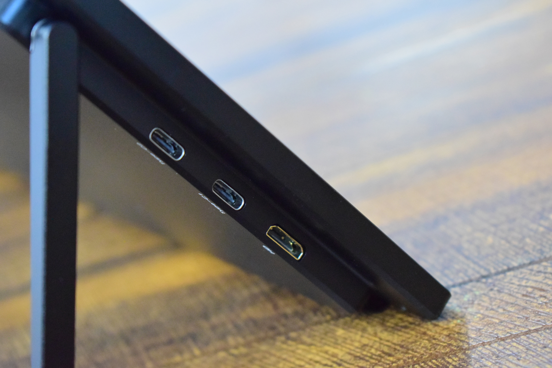A close-up of the side of an unbranded device showing two USB-C ports and one HDMI port.
