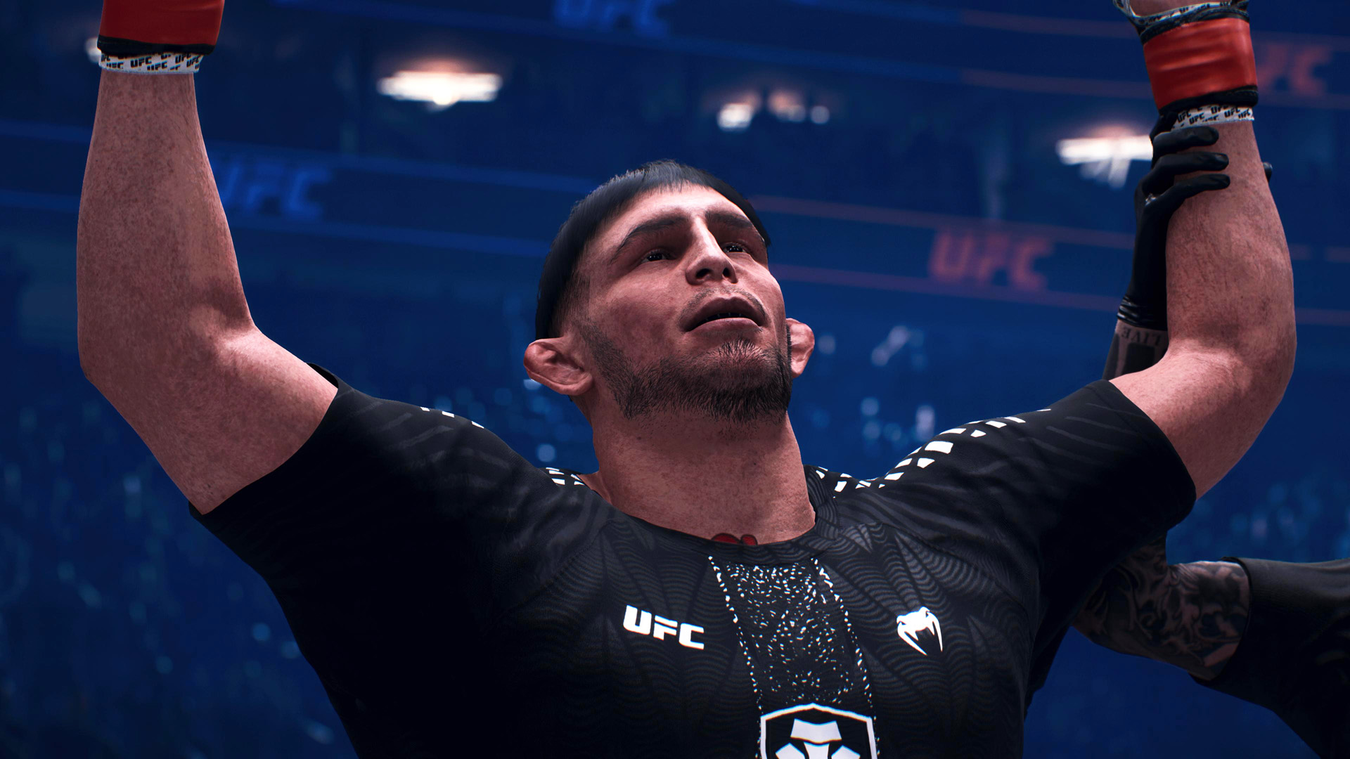 A fighter with a black 'UFC' shirt and red gloves raises his arm victoriously inside an octagonal arena in a UFC video game.