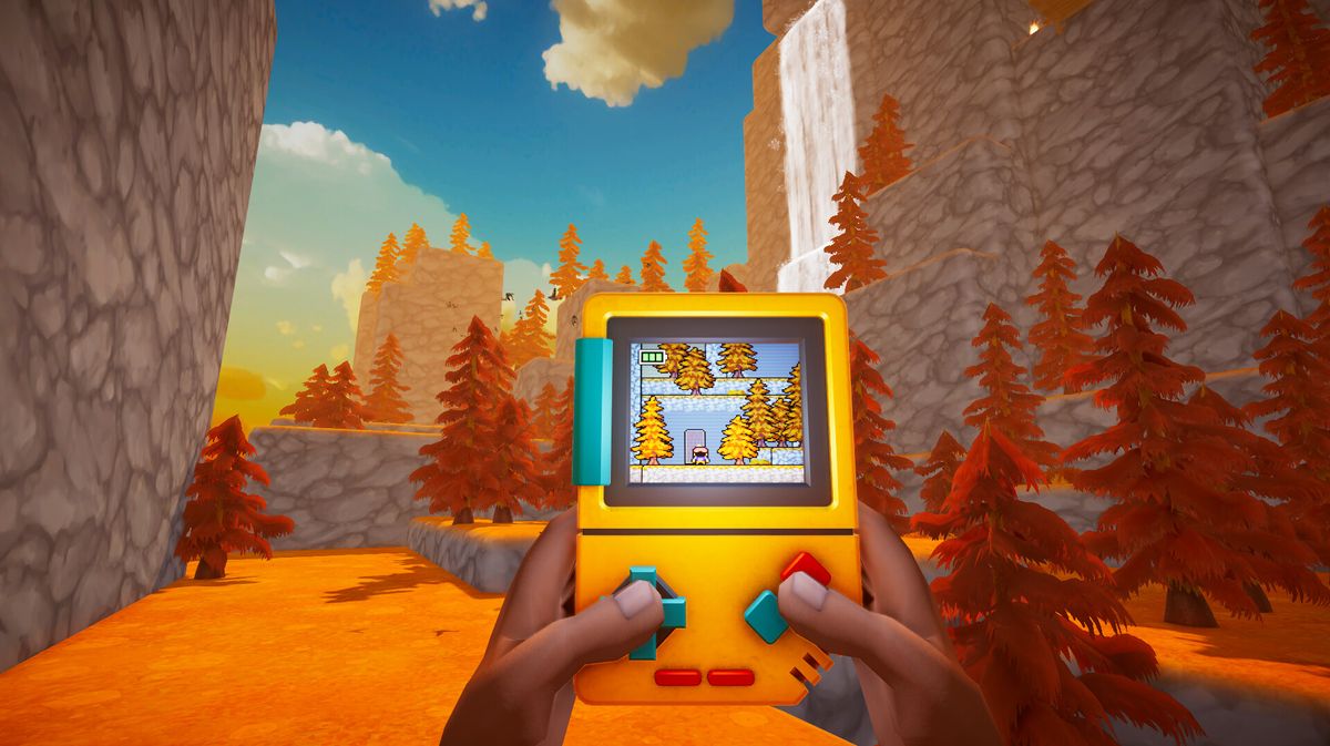 A person holds a yellow handheld gaming console showing a pixelated game with trees and a character, set against a vibrant autumn landscape with orange trees and rocky cliffs.