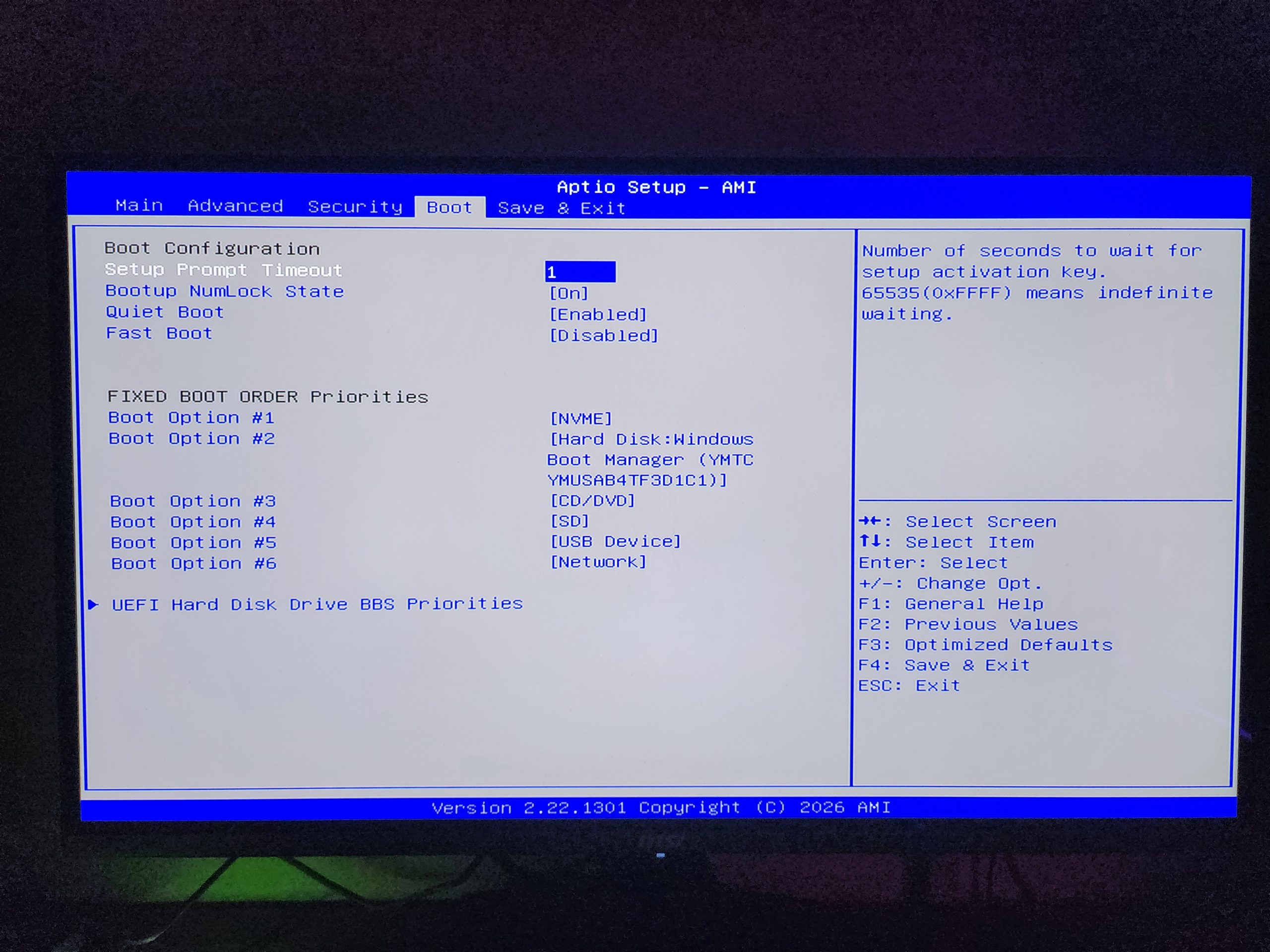The BIOS setup screen of 'Aptio Setup - AMI' shows boot configuration settings with 'Boot Option #1' set to '[NVME]' and 'Boot Option #2' set to 'Hard Disk: Windows Boot Manager (YMTC YMUSAB41TF3D1C1)'.