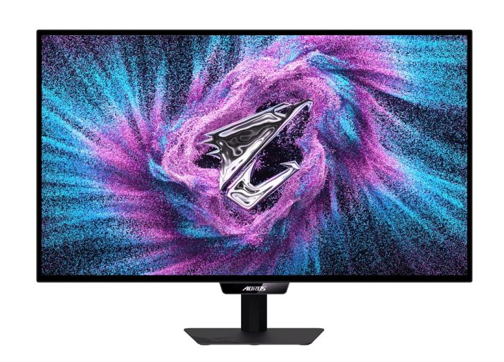 A Gigabyte AORUS monitor displays a vibrant purple and blue swirl with a metallic Z logo in the center.