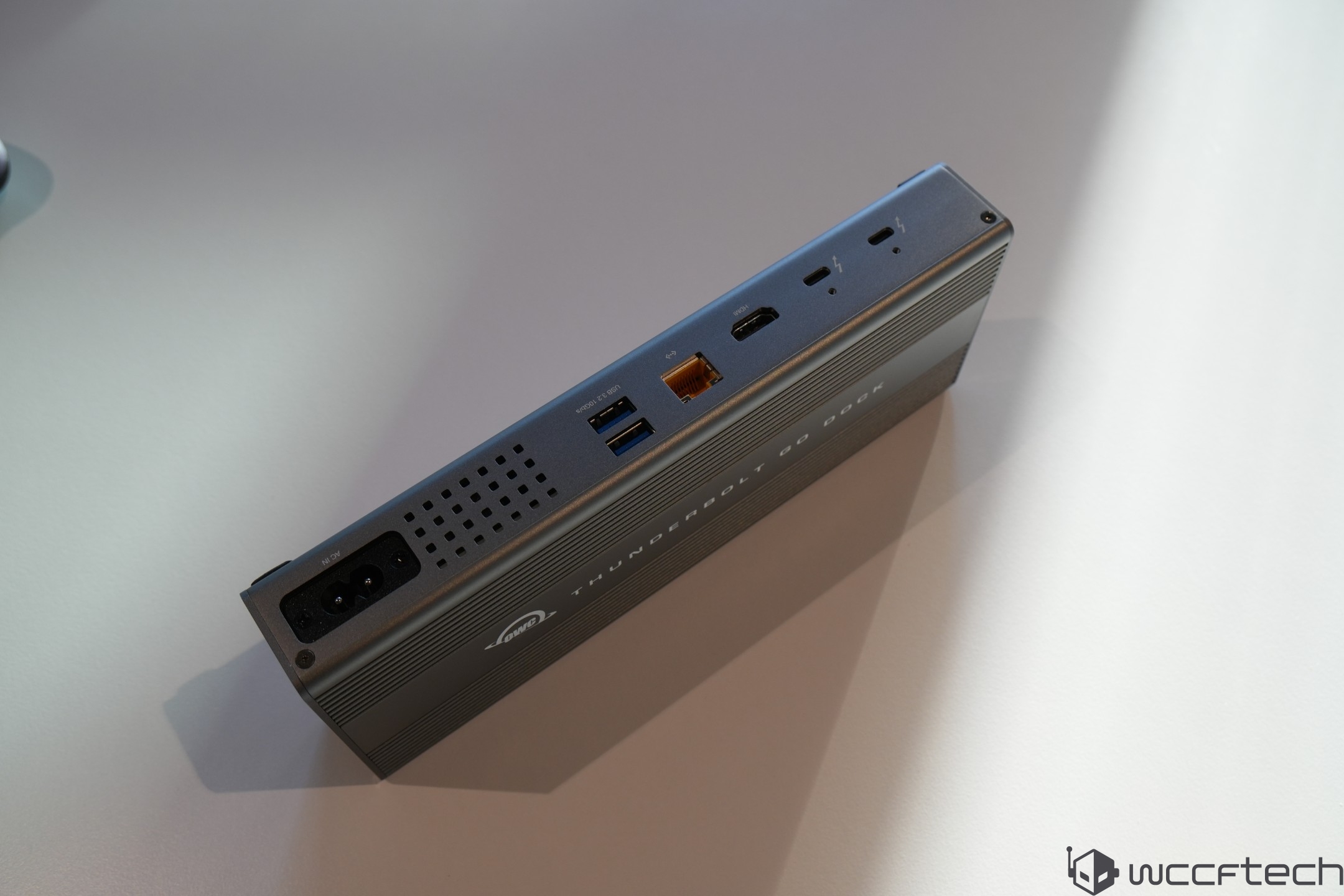 A Thunderbolt GO Dock with various input and output ports is placed on a table.