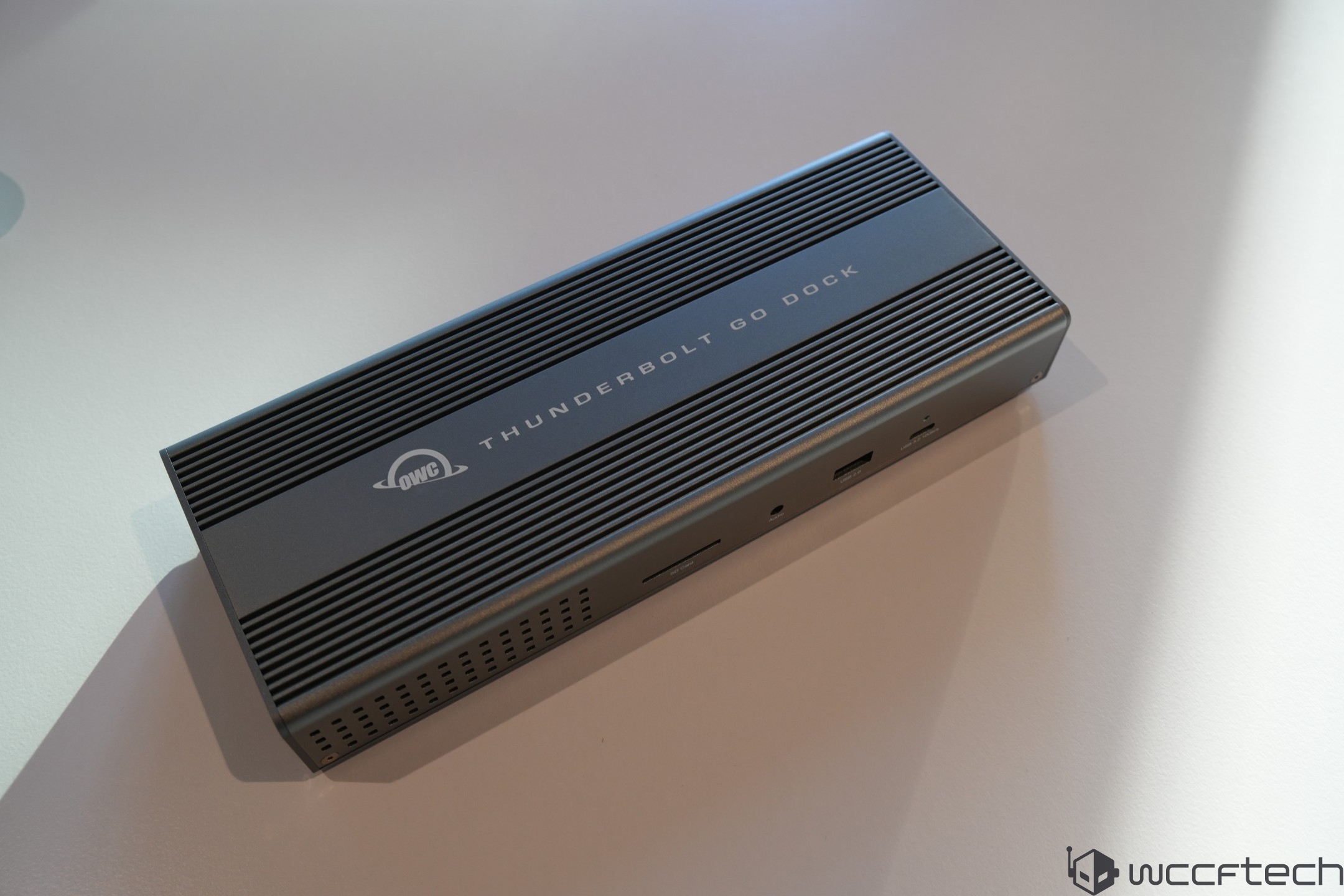 OWC Thunderbolt Go Dock resting on a light surface with visible ports and 'THUNDERBOLT GO DOCK' text on top.