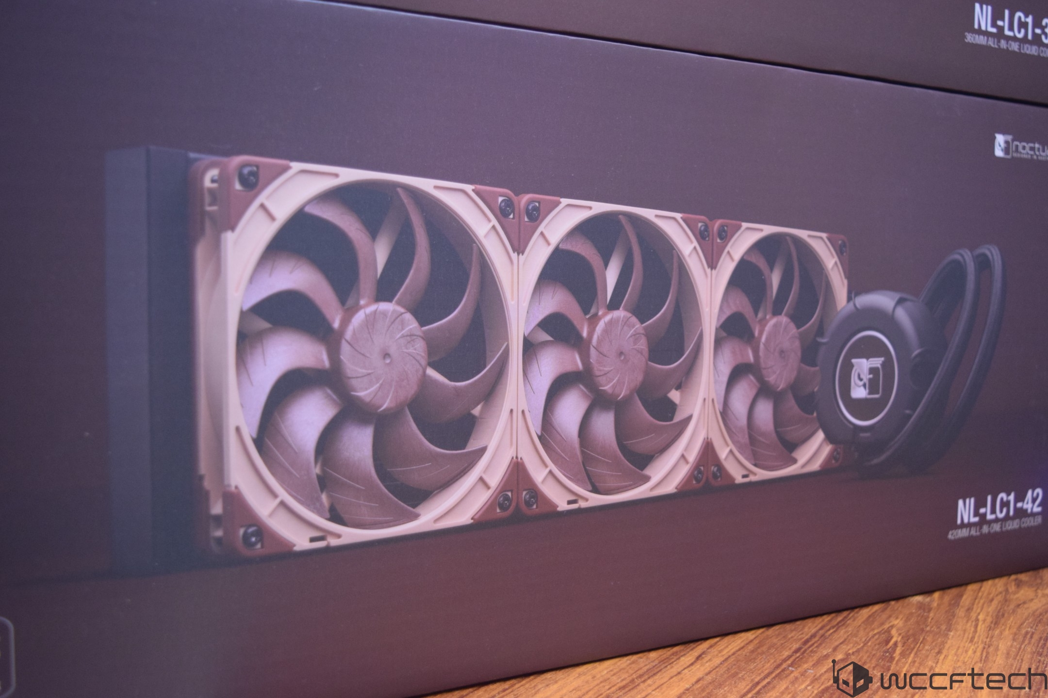 A Noctua NL-LC1-42 420mm all-in-one liquid cooler is displayed on a product box with a triple-fan design.