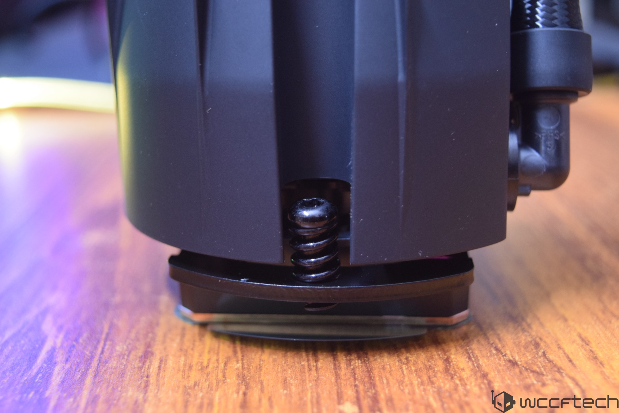 A close-up of an unbranded CPU cooler base with visible mounting screws.