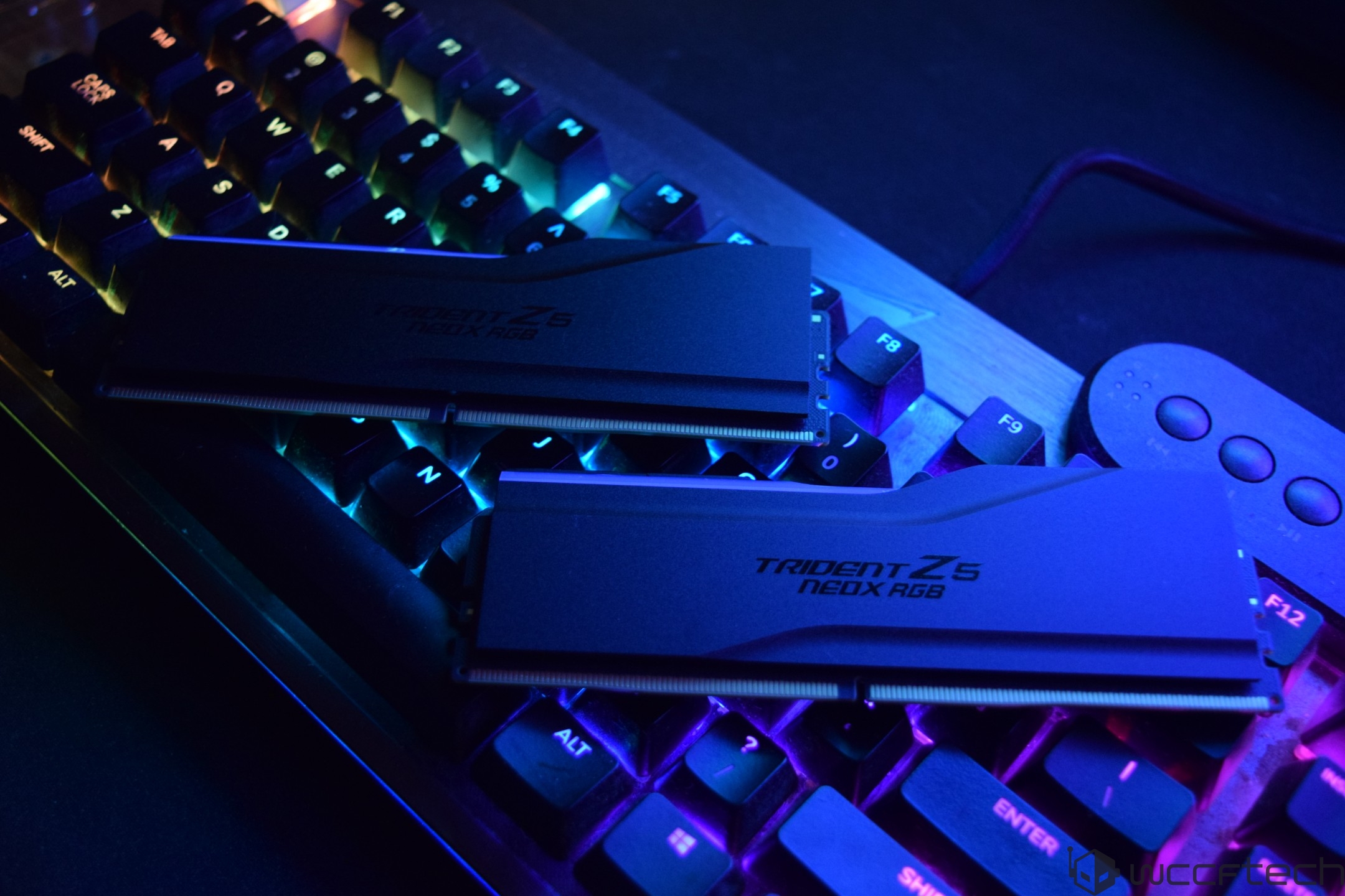 Two G.Skill Trident Z5 Neo X RGB RAM modules resting on an illuminated mechanical keyboard.