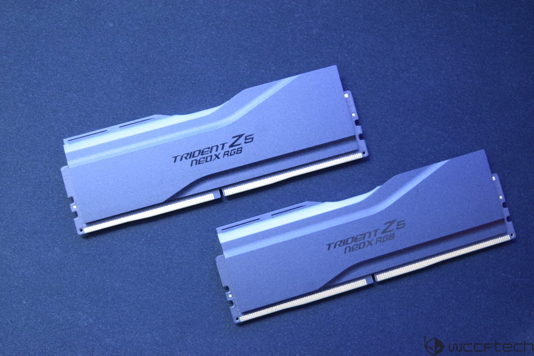 Two G.Skill Trident Z5 Neo X RGB RAM modules on a blue surface.