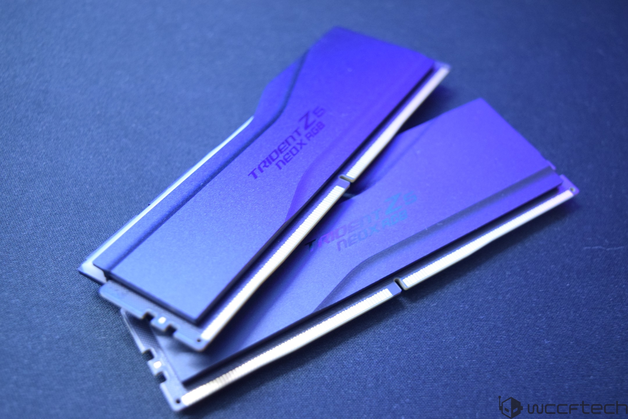 Two G.Skill Trident Z5 Neo RGB RAM modules rest on a dark surface.